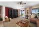 Cozy living room with carpet, a dark entertainment center, and a sliding glass door to the backyard at 18375 E San Ignacio Ct, Gold Canyon, AZ 85118