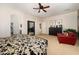 Spacious main bedroom featuring carpet flooring and a cozy red armchair at 18375 E San Ignacio Ct, Gold Canyon, AZ 85118