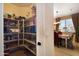 Walk-in pantry with shelving, adjacent to a dining area with a table and chairs at 18375 E San Ignacio Ct, Gold Canyon, AZ 85118
