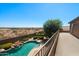 Backyard pool and patio area offer a peaceful retreat with desert views beyond the perimeter wall at 18375 E San Ignacio Ct, Gold Canyon, AZ 85118
