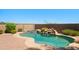 Backyard pool with stone waterfall, spa, and desert landscaping creates a serene outdoor oasis at 18375 E San Ignacio Ct, Gold Canyon, AZ 85118