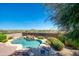 Stunning pool with rock waterfall and desert landscaping, perfect for relaxation and entertaining at 18375 E San Ignacio Ct, Gold Canyon, AZ 85118