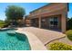 Inviting pool area featuring a brick patio and meticulously manicured landscaping, perfect for outdoor enjoyment at 18375 E San Ignacio Ct, Gold Canyon, AZ 85118