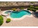 Inviting pool and spa with stone waterfall feature and desert landscaping in a private backyard at 18375 E San Ignacio Ct, Gold Canyon, AZ 85118