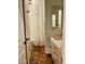 Full bathroom has vanity, tile floor and rose-patterned shower curtain at 20502 W Ridge Rd, Buckeye, AZ 85396