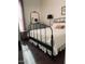 Bedroom boasts hardwood flooring, iron bed frame, and accent furniture at 20502 W Ridge Rd, Buckeye, AZ 85396