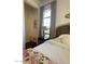 Bedroom with a large window, side table, and cozy decor at 20502 W Ridge Rd, Buckeye, AZ 85396