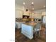 Spacious kitchen features a center island, granite countertops, stainless steel appliances, and custom cabinetry at 20502 W Ridge Rd, Buckeye, AZ 85396