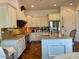 Modern kitchen with stainless steel appliances, granite countertops, and white cabinetry provides ample space and storage at 20502 W Ridge Rd, Buckeye, AZ 85396