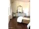 Tranquil main bedroom featuring hardwood floors, a decorative mirror and a comfortable chaise lounge at 20502 W Ridge Rd, Buckeye, AZ 85396