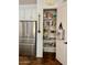 Pantry with ample storage shelves, alongside a modern stainless steel refrigerator at 20502 W Ridge Rd, Buckeye, AZ 85396