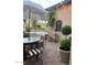 Outdoor patio with umbrella, seating, and manicured landscaping at 20502 W Ridge Rd, Buckeye, AZ 85396