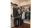 Organized walk-in closet with shelves, hanging rods, and hardwood floor at 20502 W Ridge Rd, Buckeye, AZ 85396