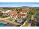 Aerial view of home featuring covered patio, outdoor kitchen, pool, pergola, and mountain views at 20518 W White Rock Rd, Buckeye, AZ 85396