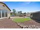 Expansive backyard featuring a gazebo, playhouse, and charming rock accents at 20518 W White Rock Rd, Buckeye, AZ 85396