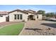 Beautiful backyard boasts artificial grass, gravel, and covered patio for outdoor enjoyment at 20518 W White Rock Rd, Buckeye, AZ 85396