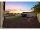 Spacious backyard with playhouse, artificial turf, and stone features, perfect for entertaining at 20518 W White Rock Rd, Buckeye, AZ 85396