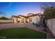 House with sprawling backyard, stone patio with a fire pit, and covered outdoor space at 20518 W White Rock Rd, Buckeye, AZ 85396