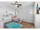 Charming bedroom featuring a ceiling fan, carpeted floors, a vanity, and a cozy twin bed with a colorful rug at 20518 W White Rock Rd, Buckeye, AZ 85396