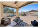 Relaxing covered patio featuring comfortable seating, perfect for enjoying the serene backyard view at 20518 W White Rock Rd, Buckeye, AZ 85396