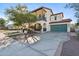 Beautiful home showcasing a balcony, two-car garage, and lovely landscaping at 20518 W White Rock Rd, Buckeye, AZ 85396