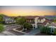 Beautiful two-story home with balcony, mountains, red tile roof, and lush landscaping at 20518 W White Rock Rd, Buckeye, AZ 85396