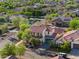 Exterior shot of house with lush landscaping and mature trees in quiet neighborhood at 20518 W White Rock Rd, Buckeye, AZ 85396