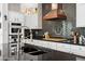 Close up of a gorgeous kitchen with granite counters, modern appliances, and a stylish tile backsplash at 20518 W White Rock Rd, Buckeye, AZ 85396