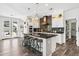 Modern kitchen with an island, bar seating, updated appliances, and pendant lighting above the island at 20518 W White Rock Rd, Buckeye, AZ 85396