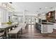 An open kitchen and dining area boasts an island, updated appliances, and a clear view to the backyard at 20518 W White Rock Rd, Buckeye, AZ 85396