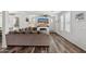 Bright living room featuring modern decor, wood floors, and a cozy fireplace at 20518 W White Rock Rd, Buckeye, AZ 85396
