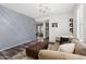 Open living room with gray accent wall, hardwood floors, and comfortable seating with a view into the other rooms at 20518 W White Rock Rd, Buckeye, AZ 85396
