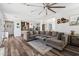 Open living area with wood floors, a large sectional sofa and decor pieces throughout at 20518 W White Rock Rd, Buckeye, AZ 85396