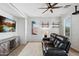 Living room featuring a media center, ceiling fan, a black leather recliner and neutral colors at 20518 W White Rock Rd, Buckeye, AZ 85396