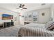 Bedroom featuring a ceiling fan, plush bedding, and a window with shutters at 20518 W White Rock Rd, Buckeye, AZ 85396