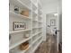 Pantry with open shelves, filled with wicker baskets and decorative items at 20518 W White Rock Rd, Buckeye, AZ 85396