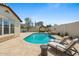 Inviting backyard pool with a waterfall feature, a gazebo, and lounge chairs at 20518 W White Rock Rd, Buckeye, AZ 85396