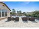Inviting backyard with a sparkling pool, outdoor seating, and manicured landscaping, perfect for relaxation and entertaining at 20518 W White Rock Rd, Buckeye, AZ 85396