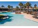 Tranquil community pool featuring sun loungers, shaded seating, and a shallow beach entry at 20518 W White Rock Rd, Buckeye, AZ 85396