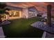 Beautiful backyard featuring a manicured lawn, desert landscaping, and spa at 22837 E Orchard Ln, Queen Creek, AZ 85142
