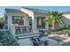 Beautiful backyard featuring a built-in grill, bar seating, palm tree, and relaxing firepit area at 22837 E Orchard Ln, Queen Creek, AZ 85142