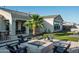 Relaxing backyard boasts artificial turf, a firepit, and a beautiful palm tree at 22837 E Orchard Ln, Queen Creek, AZ 85142
