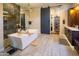 Elegant bathroom featuring a modern soaking tub, walk-in shower, and stylish fixtures at 22837 E Orchard Ln, Queen Creek, AZ 85142