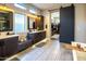 Spacious bathroom with dual sinks, soaking tub, walk-in closet, and sleek, contemporary design at 22837 E Orchard Ln, Queen Creek, AZ 85142