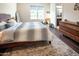 Inviting bedroom with a plush bed, hardwood floors, large windows, and a view into the Primary bathroom at 22837 E Orchard Ln, Queen Creek, AZ 85142
