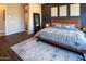 Well-appointed bedroom with dark accent wall, wood flooring, and a cozy, relaxing ambiance at 22837 E Orchard Ln, Queen Creek, AZ 85142