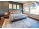 Comfortable bedroom featuring modern decor, a large window, and a peaceful, inviting atmosphere at 22837 E Orchard Ln, Queen Creek, AZ 85142