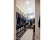 Well-organized walk-in closet with ample hanging space, shelving, storage boxes, and a stylish rug at 22837 E Orchard Ln, Queen Creek, AZ 85142