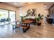 Bright dining area with wood table, bench, and large windows overlooking outdoor living space at 22837 E Orchard Ln, Queen Creek, AZ 85142