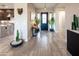 Inviting foyer with tile floors, leading to kitchen, features stylish decor and ample natural light at 22837 E Orchard Ln, Queen Creek, AZ 85142